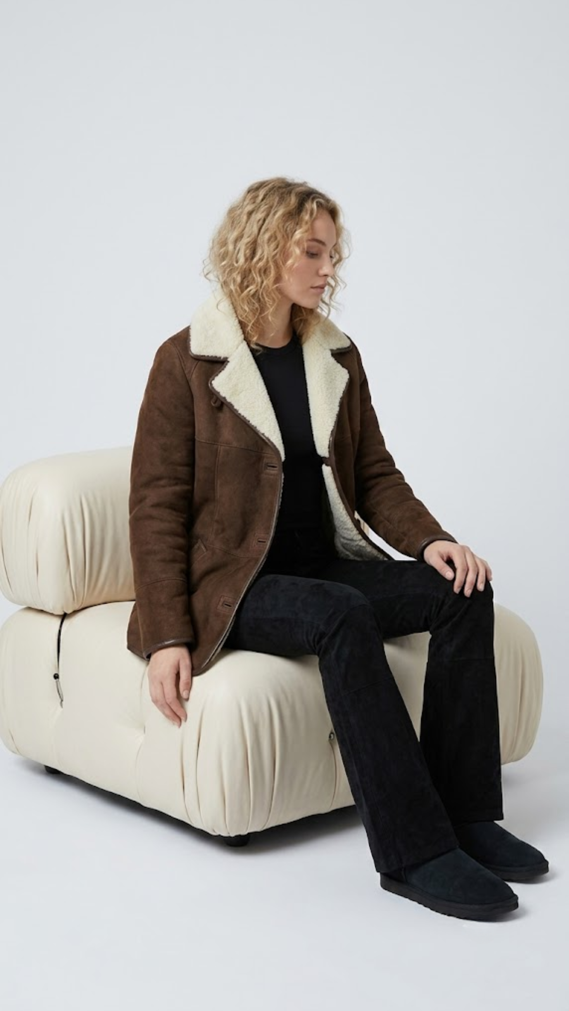 Men's luxury winter fashion featuring a sophisticated long-line dark brown suede coat with warm fur trim.