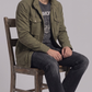 Men's modern military-inspired fashion featuring a tailored olive green field jacket styled for a sharp look.