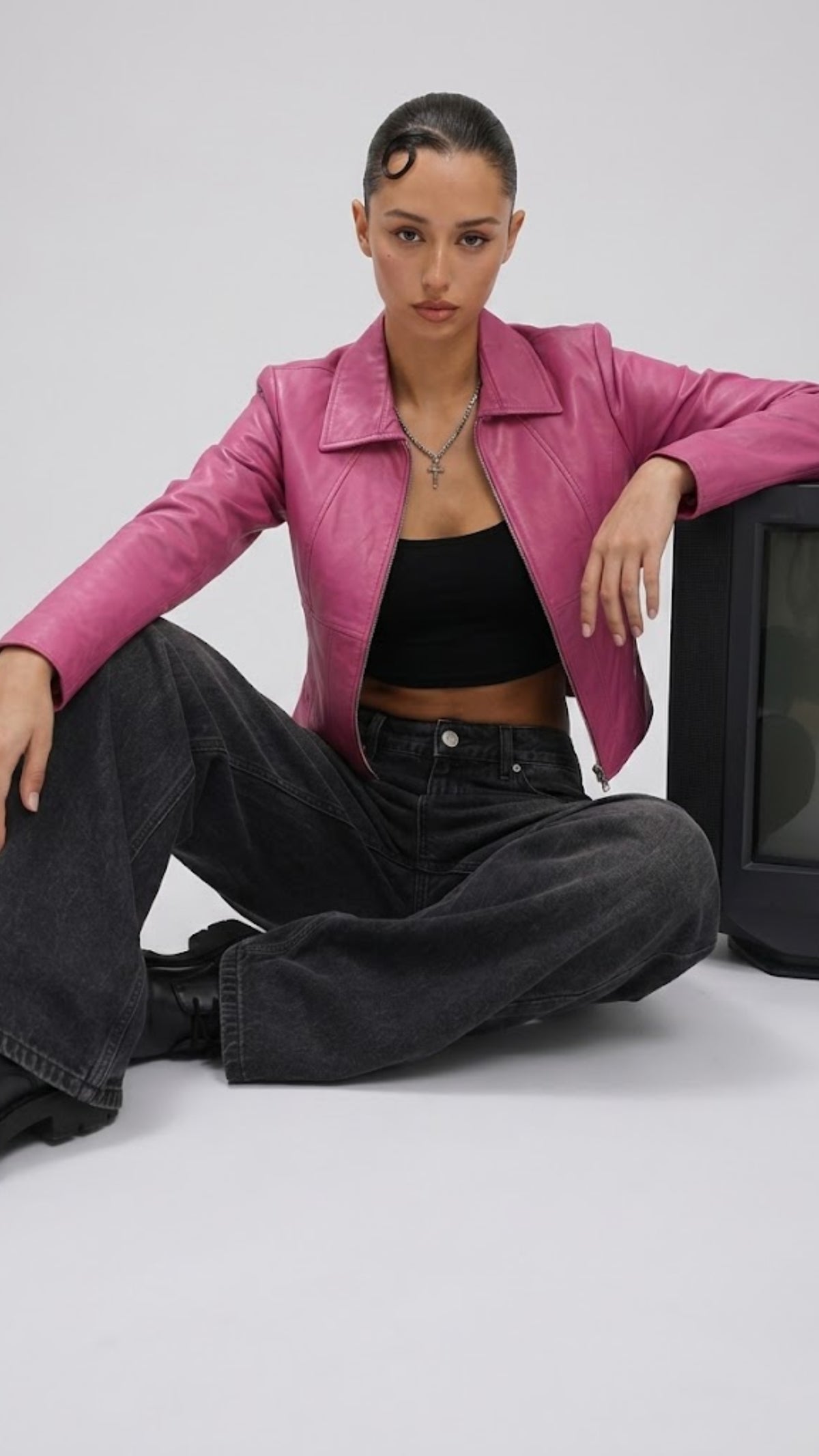 Trendy high-fashion model presentation featuring a tailored pink leather jacket styled effortlessly for an edgy streetwear look.