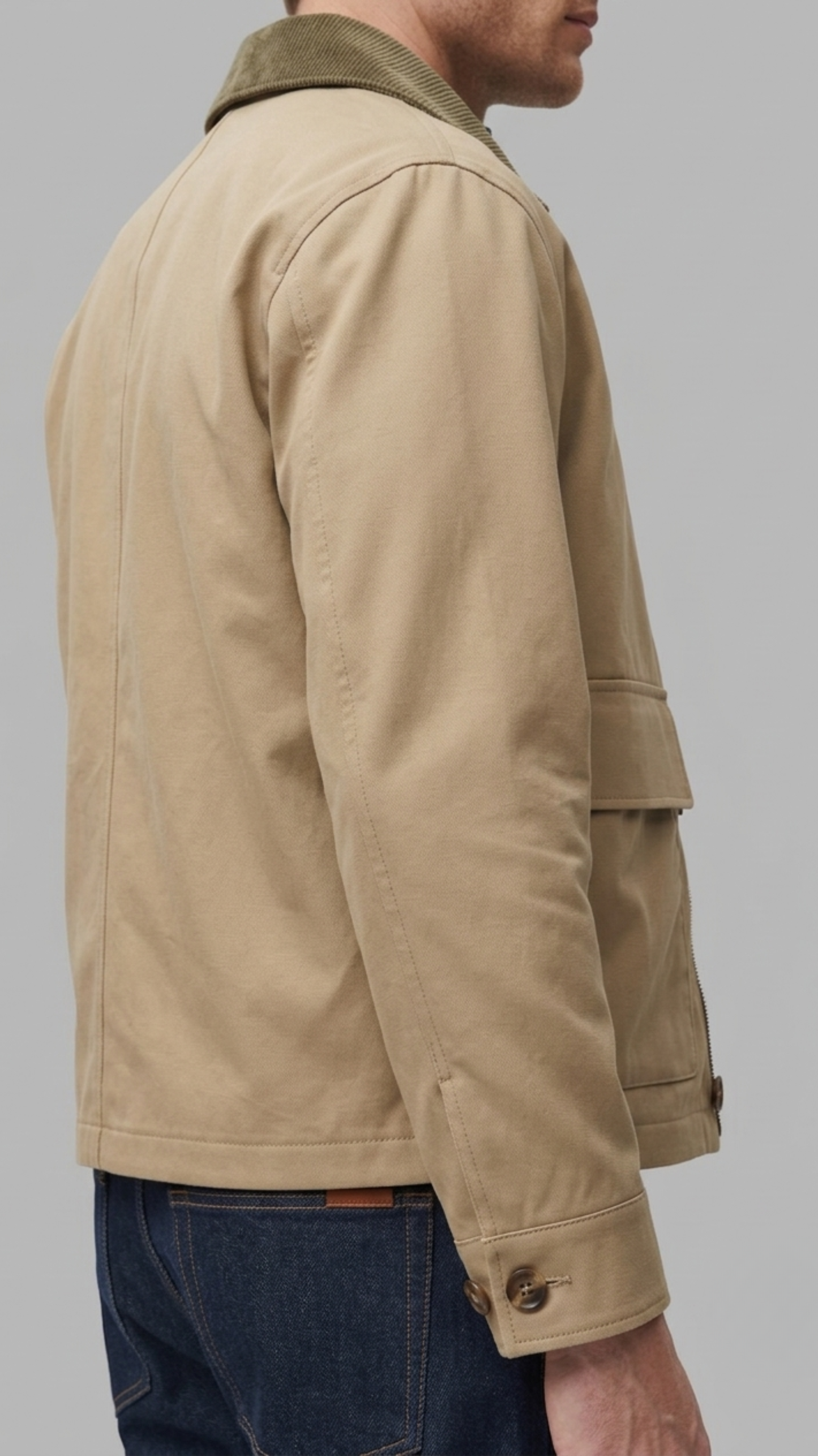 Close-up of premium breathable beige cotton fabric weave and high-quality neat stitching on the jacket collar.