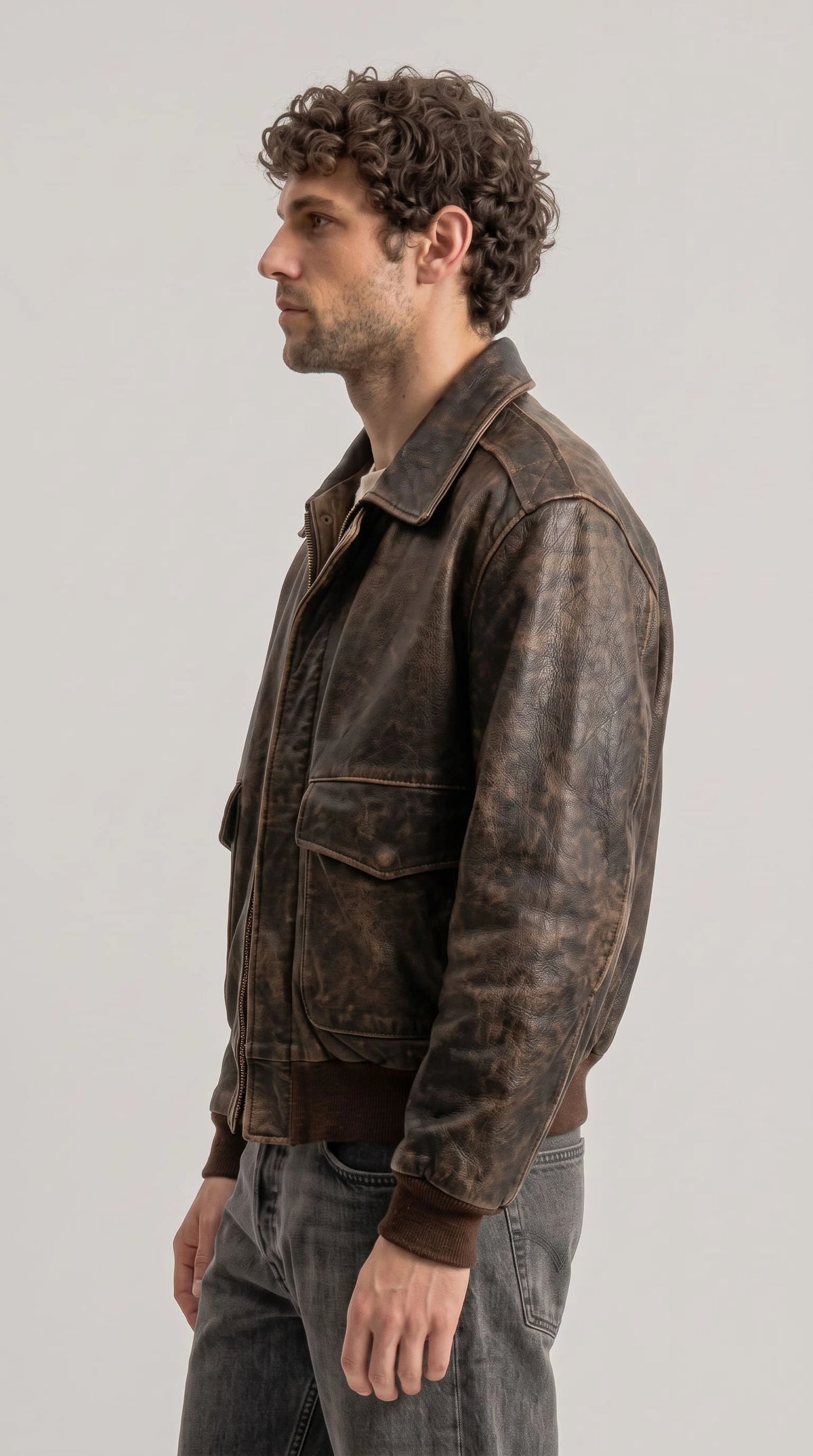 Men's rugged brown leather pilot jacket, trending 2026 fashion outerwear with weathered vintage finish, large utility flap pockets, knit cuffs and fitted hem, perfect for casual and street style