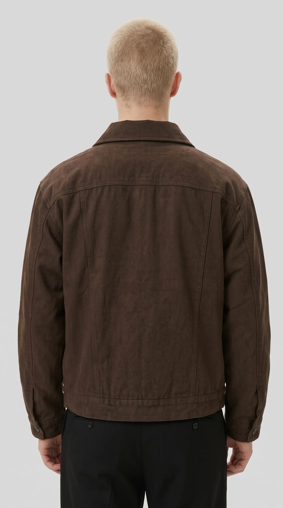 Vintage-inspired espresso brown canvas jacket featuring a broad shoulder yoke, tonal stitching, durable-looking fabric texture and a straight waist-length hem, bringing classic heritage workwear details into contemporary casual fashion.