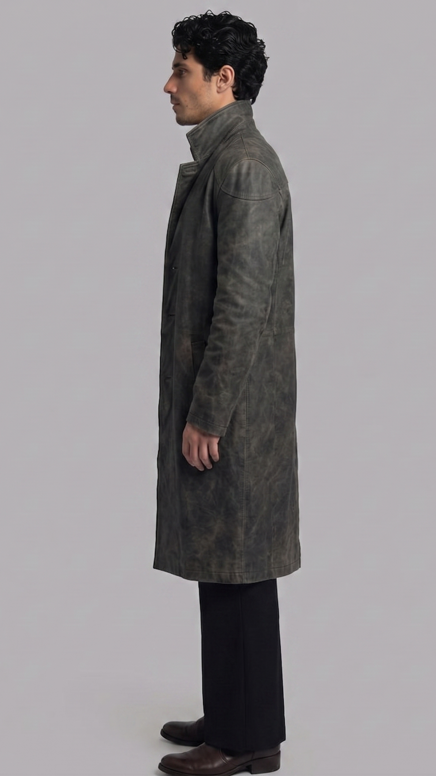 Sleek dark grey distressed leather overcoat layered elegantly over a black outfit, perfect for a high-fashion urban streetwear style.