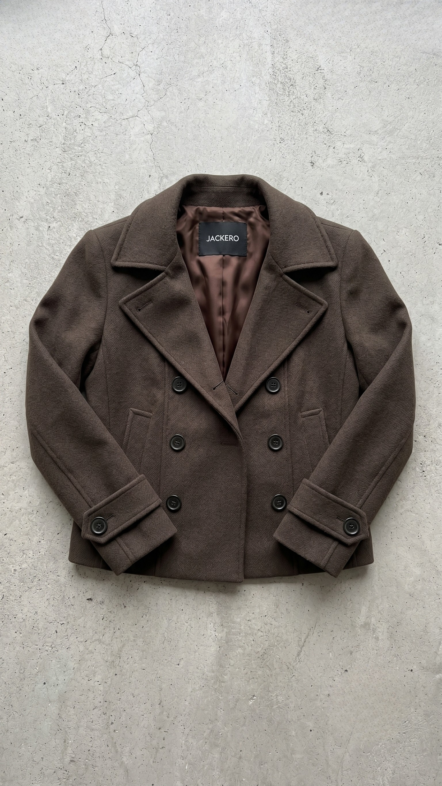 Detailed view of the texture and fabric quality of a dark brown short winter wool pea coat