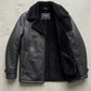 dual-textured look highlighting smooth black leather panels and thick black shearling on the lapels.