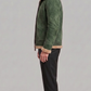 Structured olive green suede jacket showing neat stitching and premium tailored silhouette.