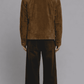 highlighting the rich velvety texture of dark mustard yellow suede paired with soft fur lining along the collar edges.