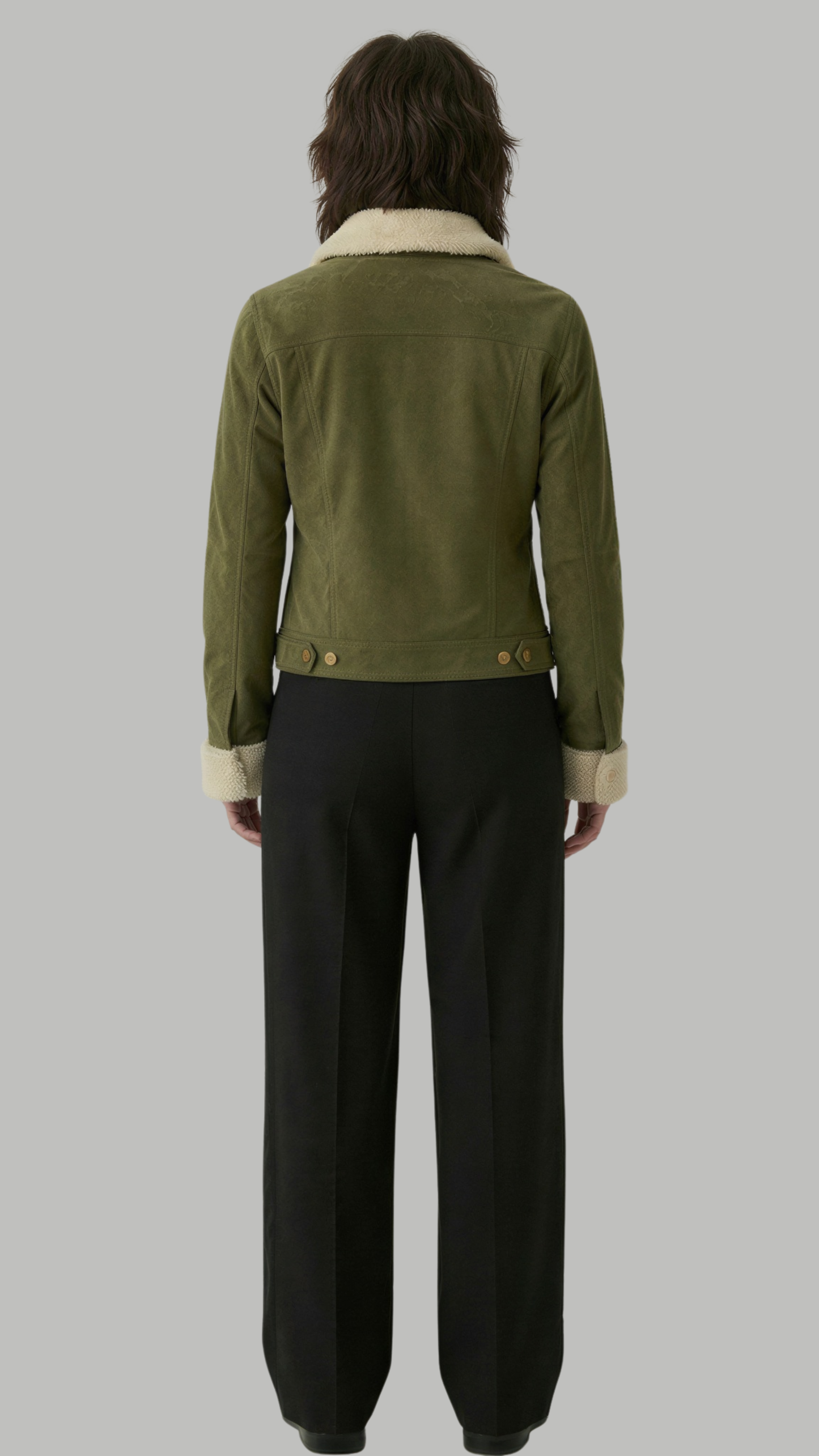 Person wearing a green jacket with a white collar and black pants on a gray background