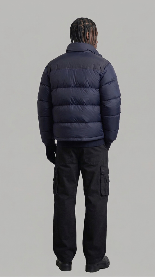 back profile showing the puffy texture and clean design of a dark navy winter outerwear piece.
