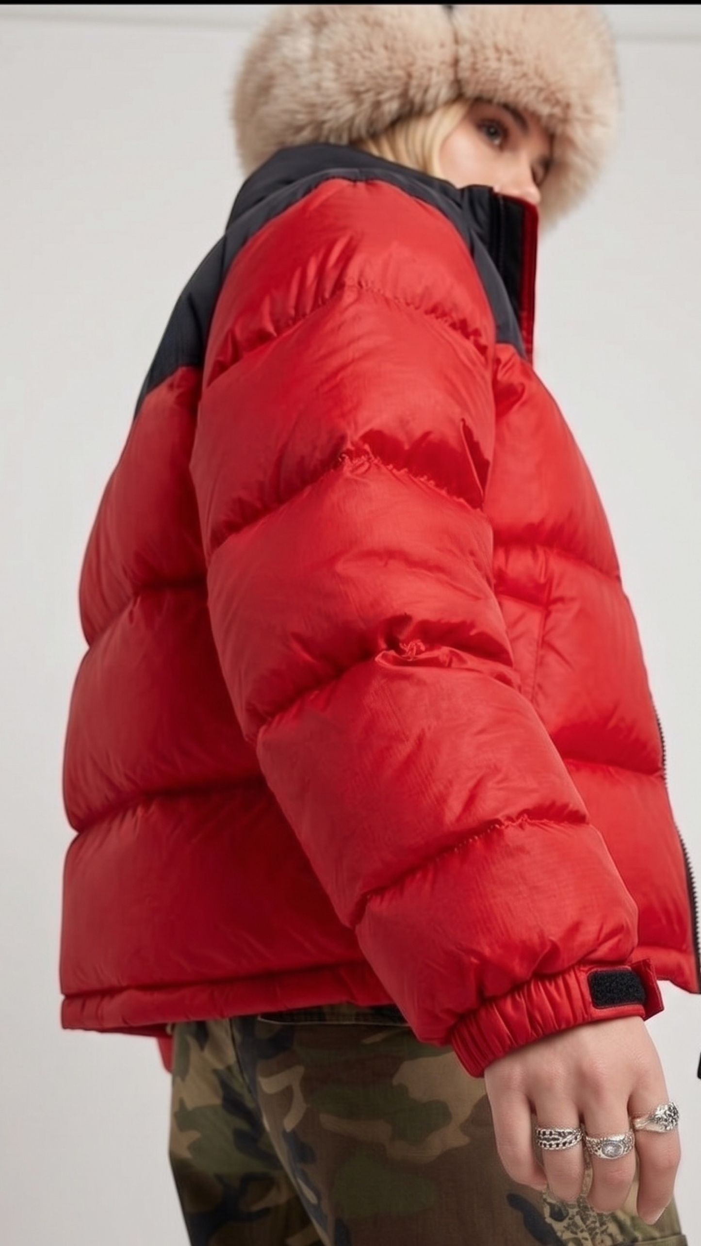 Macro detailed profile view capturing the high-density water-resistant nylon texture and premium insulated horizontal stitch lines of the red jacket.