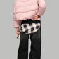 a premium baby pink winter coat showing the detailed quilted panels and fluffy fur trim on the hood.
