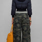 Rear view of dark navy cropped puffer jacket showing quilted baffling and fur-trimmed hood detail