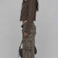 Side angle of model wearing dark khaki denim jacket with fur collar, displaying cuff buttons and relaxed fit
