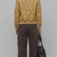 Rear view of women dark mustard leather jacket displaying precision panel stitching and tailored shoulder fit