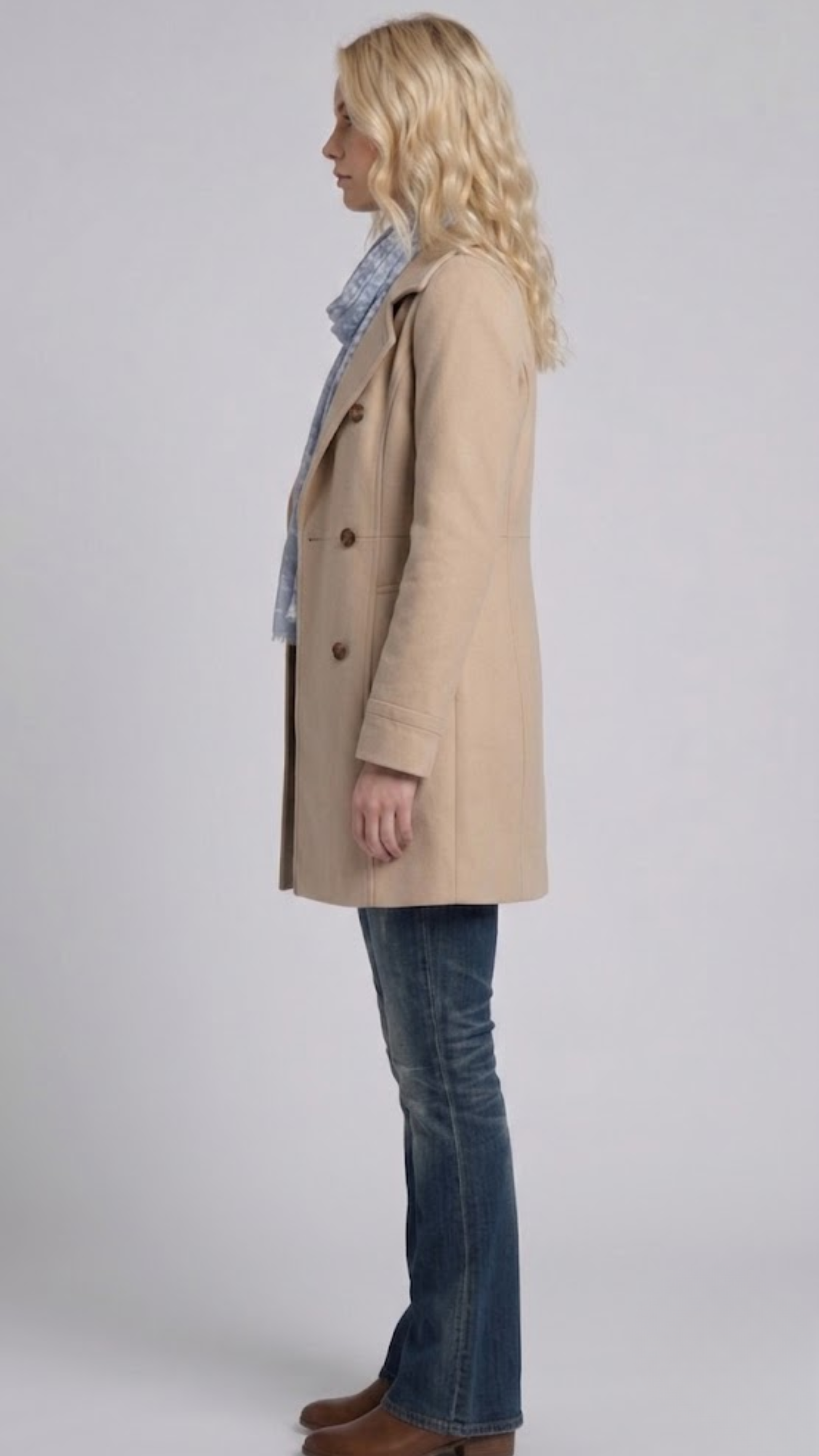 Elegant light khaki cotton overcoat layered beautifully over a casual outfit for a timeless smart-casual aesthetic.