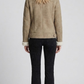 Regular fit beige suede shearling jacket layered over a casual knitted sweater for a modern urban aesthetic.