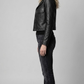 Structured design of a women's premium black leather jacket highlighting the clean lines and tailored fit