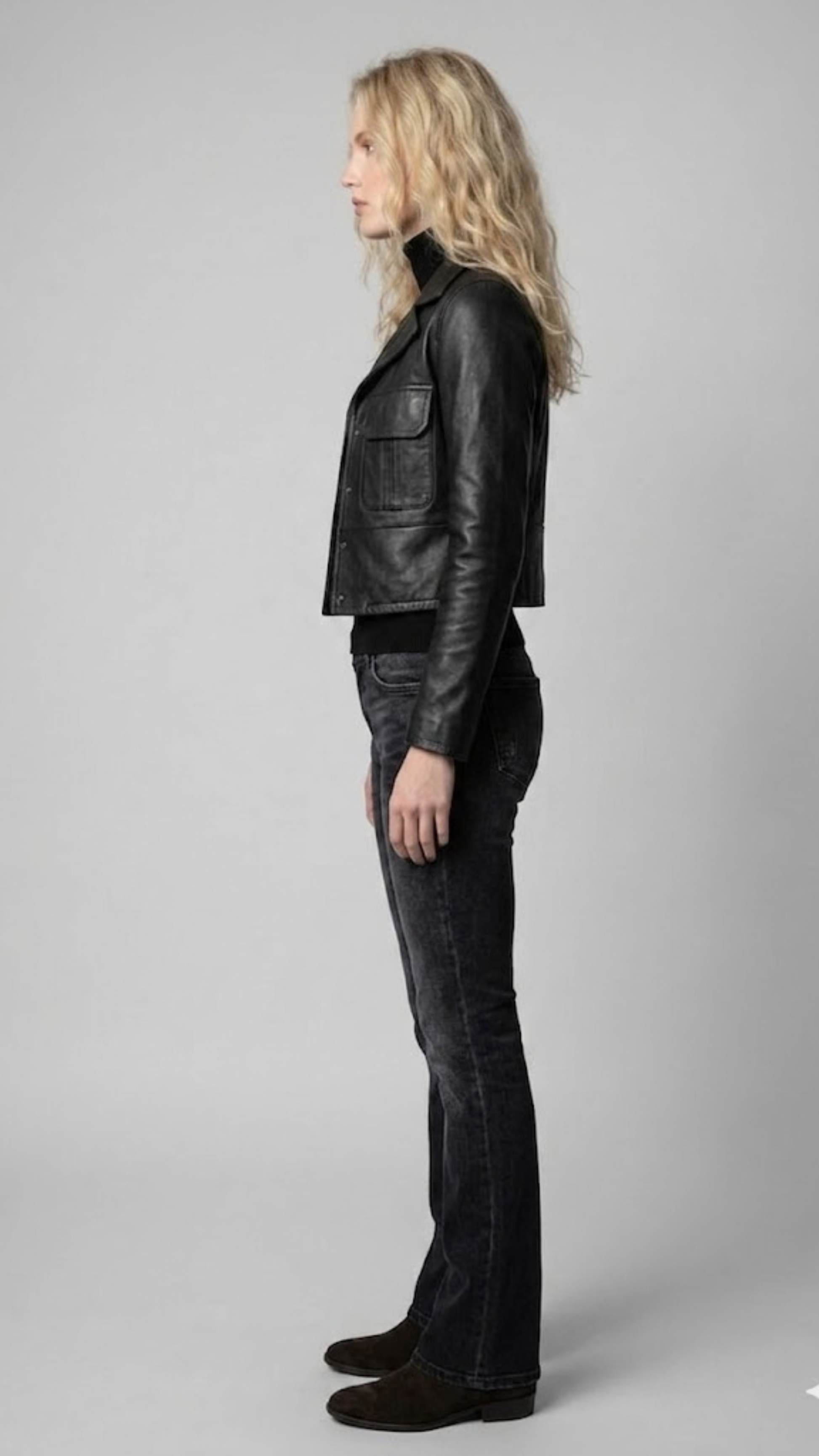 Structured design of a women's premium black leather jacket highlighting the clean lines and tailored fit