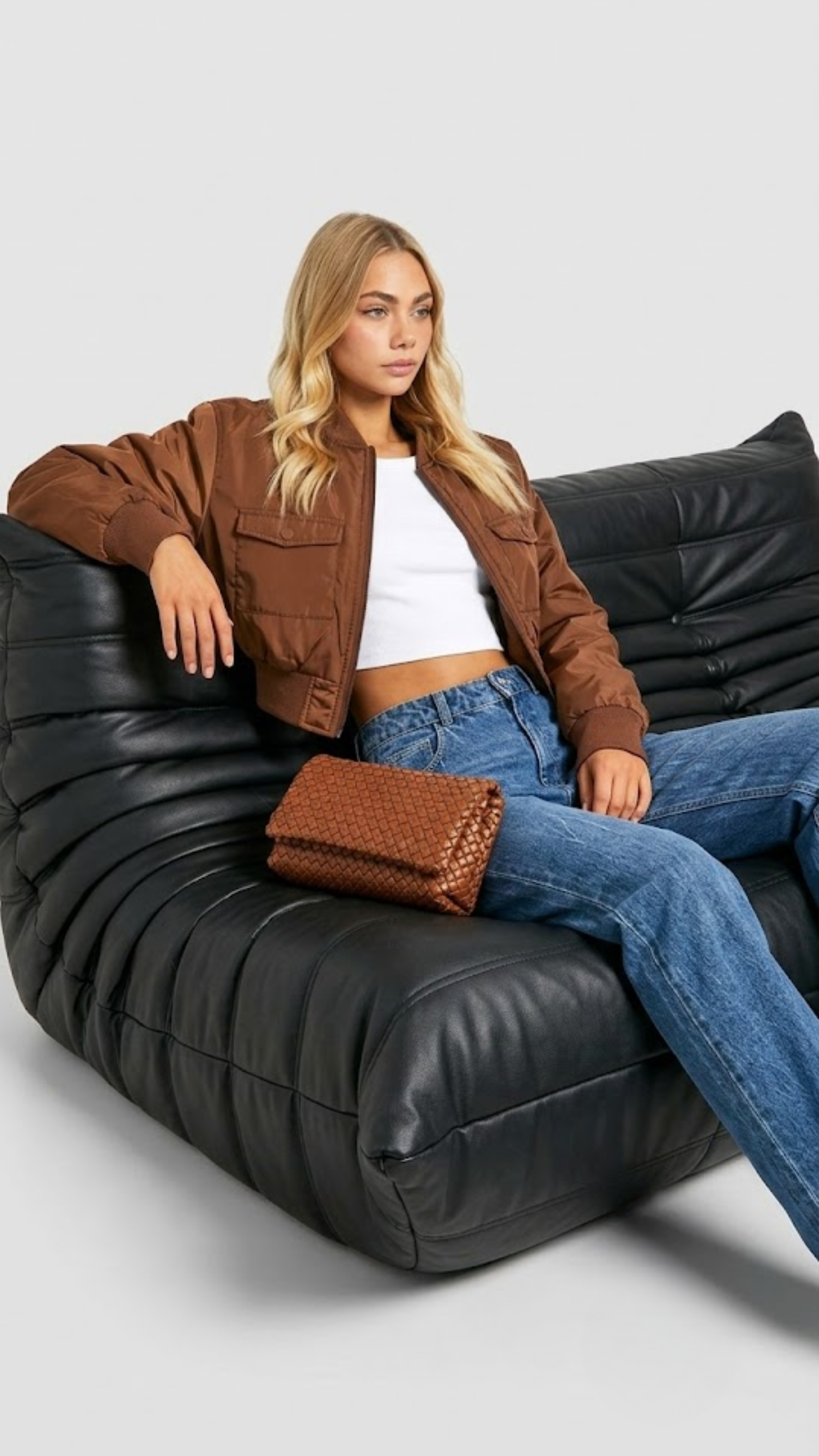 Women's contemporary high-fashion presentation featuring a sleek beige cotton silk jacket styled for an upscale casual everyday look.