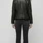 Rear view of the women's black leather biker jacket showing clean stitching and a structured fit with the faux fur collar visible.