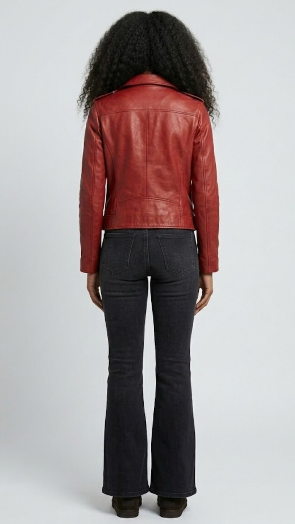 Straight-on back view of a structured red leather motorcycle jacket showcasing its tailored paneling and sharp shoulder line.