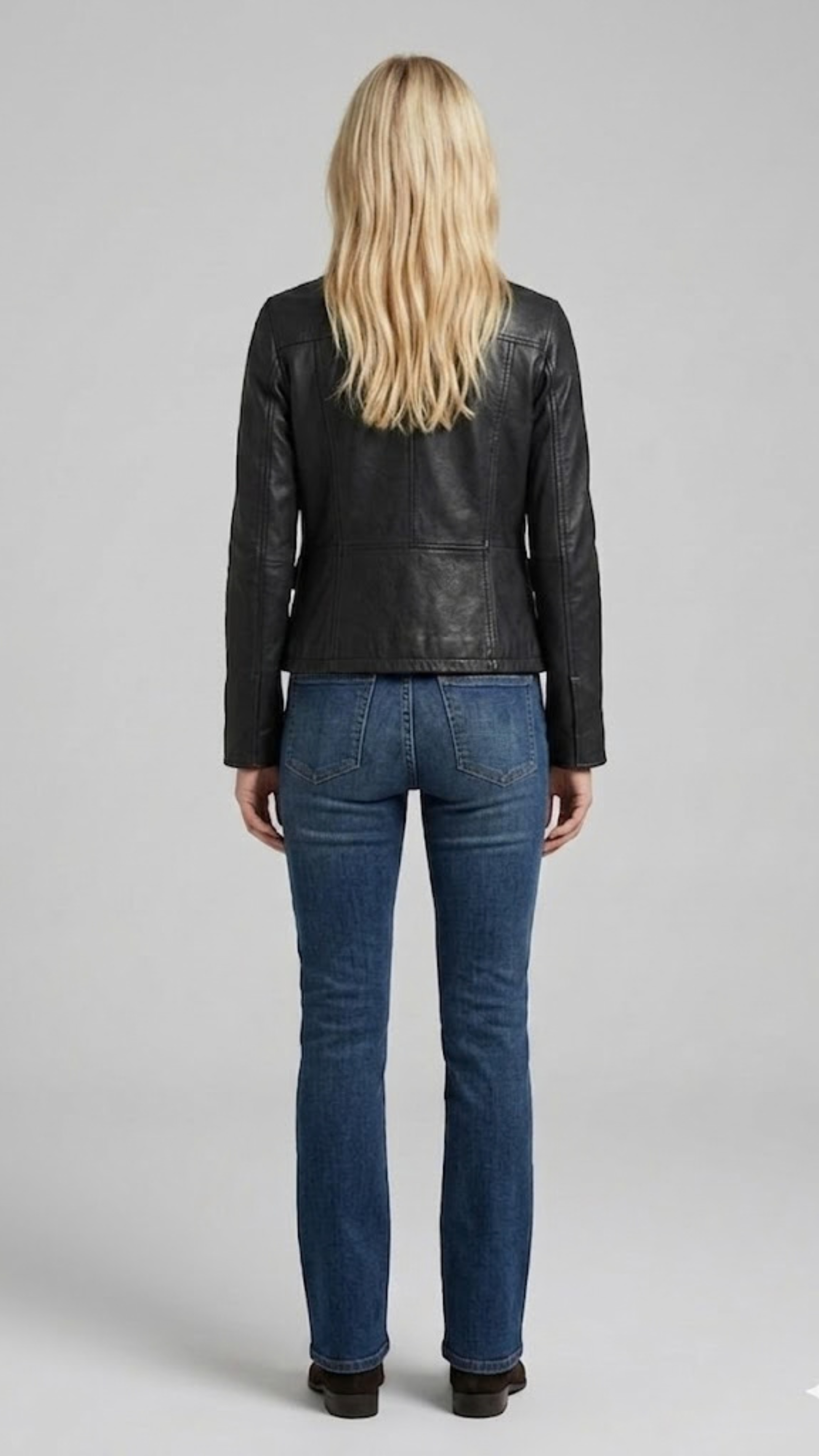 western back yoke panel and tailored seams of the onyx leather coat.