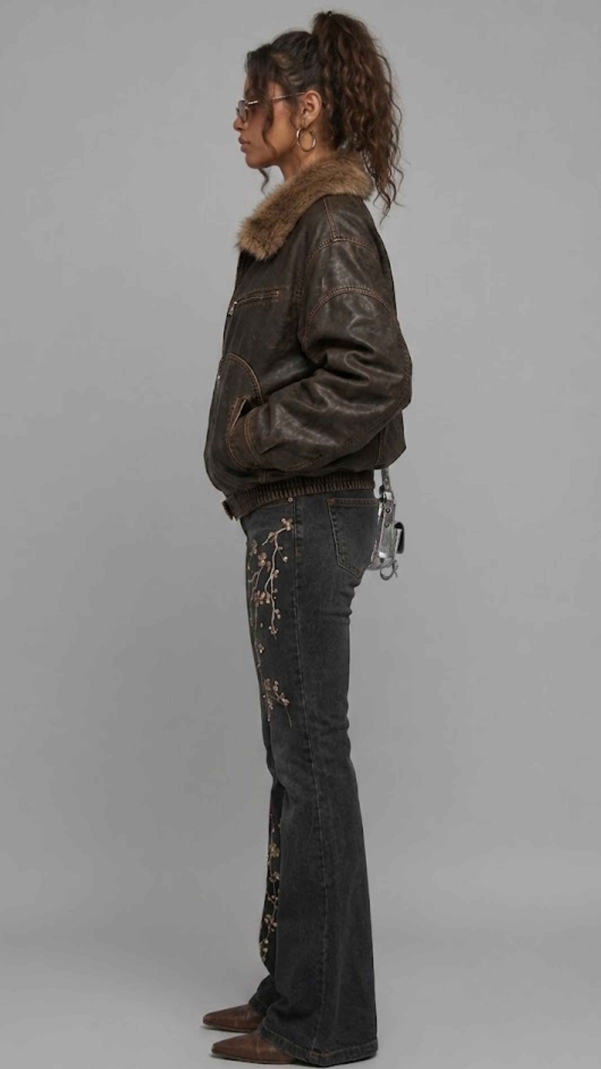 Side profile view displaying the comfortable relaxed Y2K baggy fit of a men's weathered dark brown leather bomber with soft fur accents.