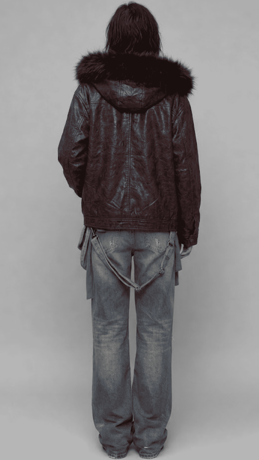 A person shown from the back wearing a JACKERO dark burgundy leather hooded jacket with a dark fur-trimmed hood, paired with faded blue jeans, against a plain light gray studio background.