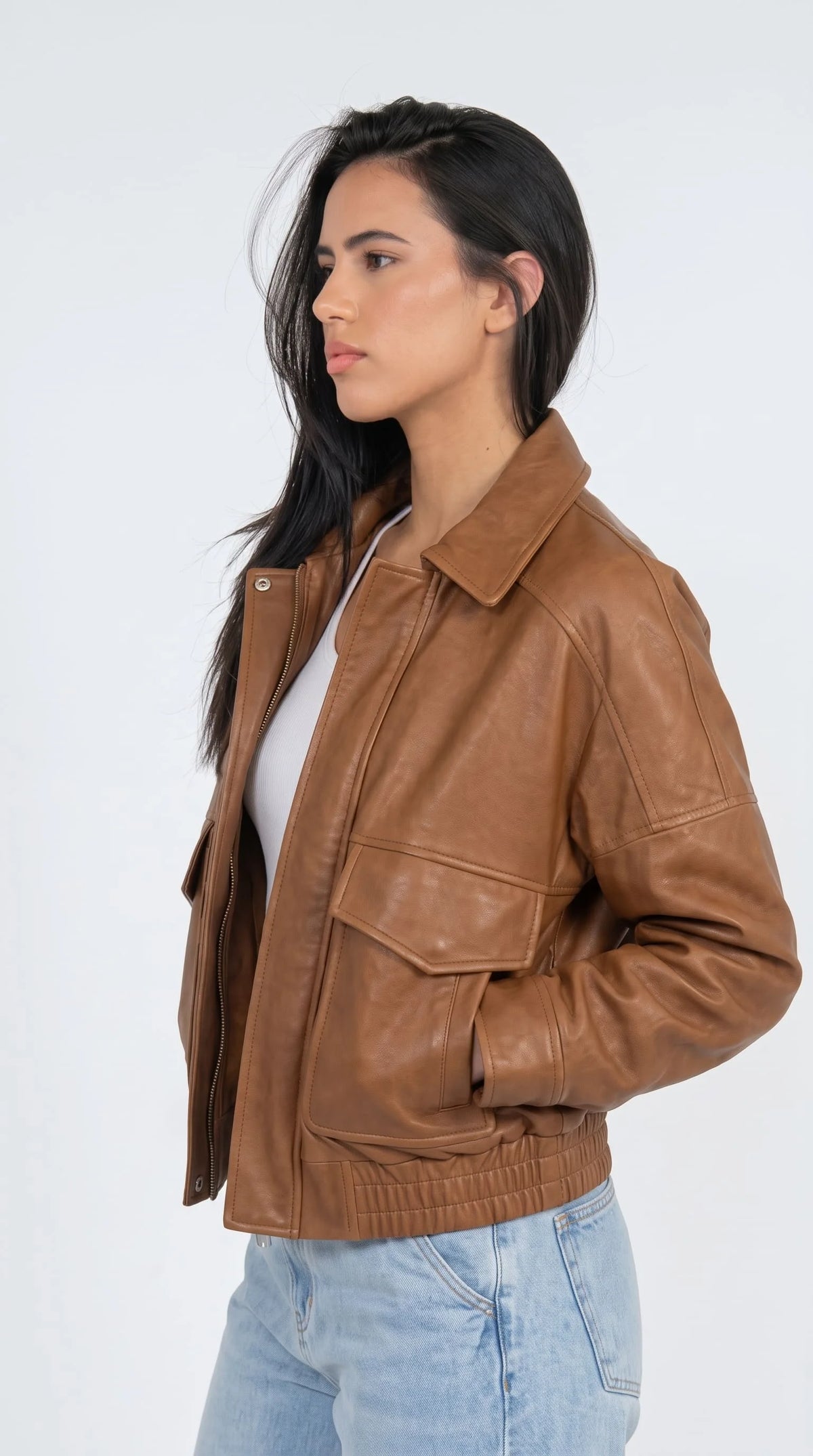 Ladies vintage brown leather flight jacket with gold zipper, structured collar, double flap front pockets and fitted ribbed hem, timeless retro fashion jacket for everyday and travel wear
