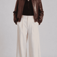 Women's rich brown leather bomber jacket featuring a glossy crocodile embossed texture and shirt collar.