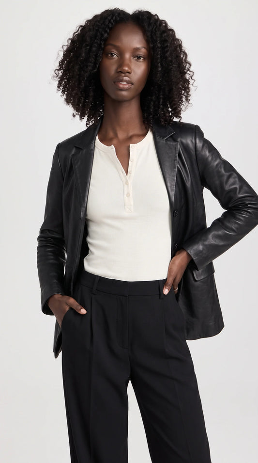 A women's black genuine leather blazer with elegant notch lapels, a contoured tailored silhouette and a clean button-front closure creates a confident, polished look. Its rich black finish and structured shape make it a versatile statement layer for refined workwear, sophisticated dinner outfits and modern feminine styling.