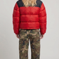 Clean rear view lookbook shot highlighting the bold black shoulder yoke and horizontal red quilted segments of the heavy winter puffer coat.