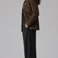 Minimalist studio fashion catalog portrait of a women's espresso brown suede button-down coat.