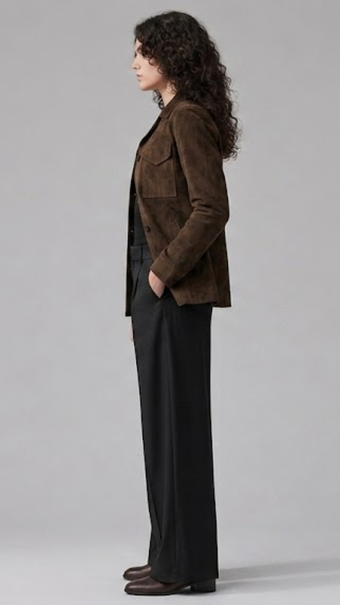 Minimalist studio fashion catalog portrait of a women's espresso brown suede button-down coat.